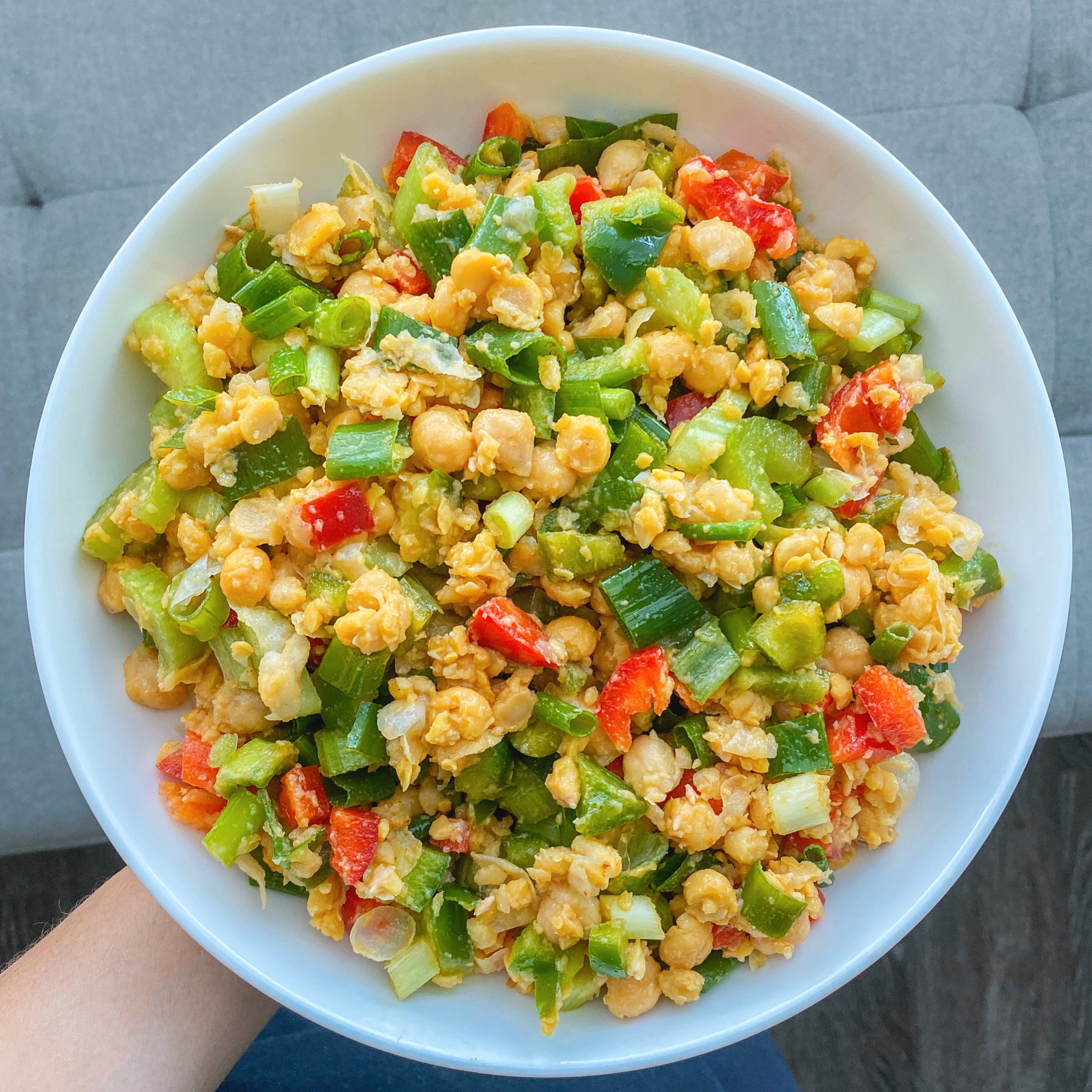 Chickpea salad served in a white bowl.