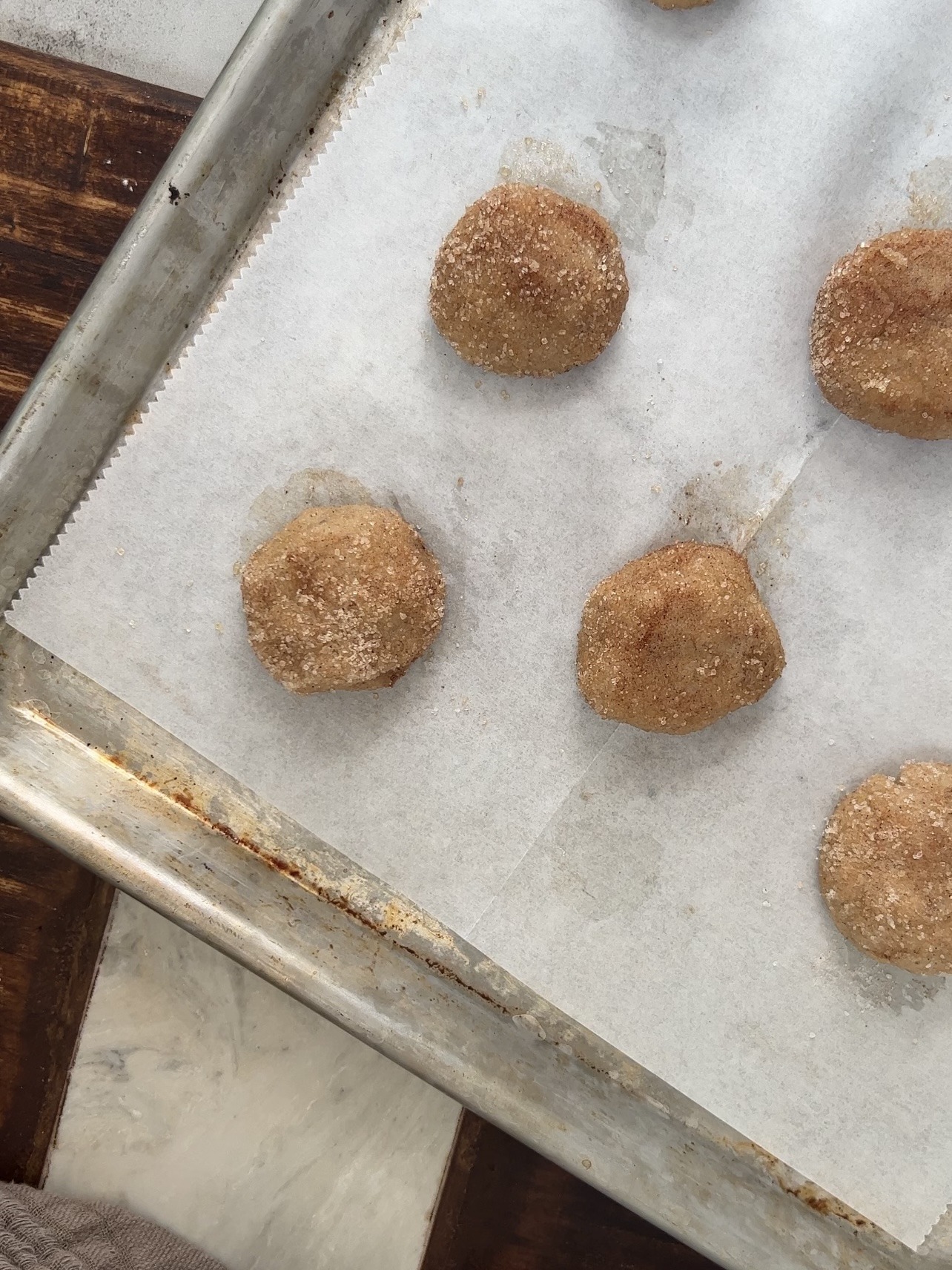 snickerdoodle cookie dough balls before baking on a baking sheet