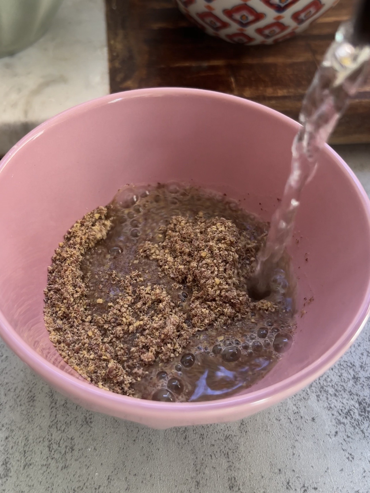 pouring water to make the flax eggs