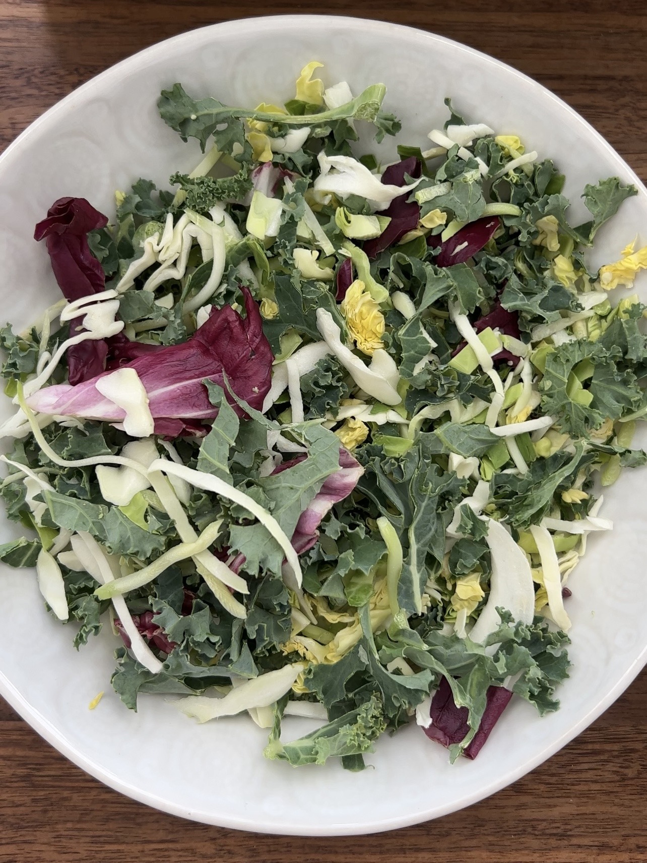 Step 2: While the chickpeas roast, prepare your rice or quinoa as instructed on the packaging. Add the shredded or chopped kale and cabbage to a bowl. Prepare the lemon juice.