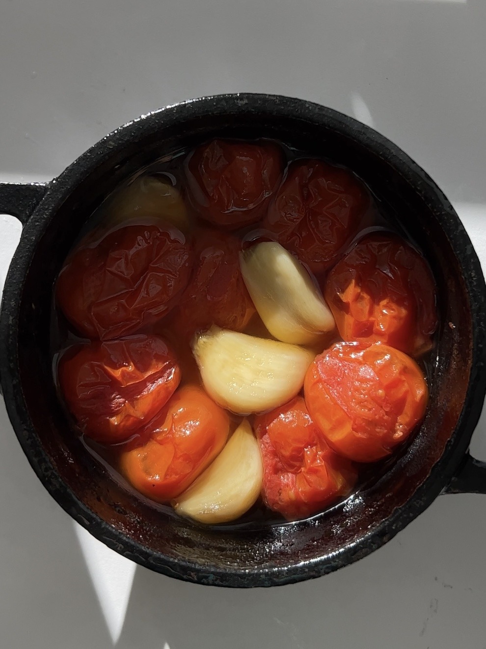 Roasted garlic and tomatoes in a cocotte. 