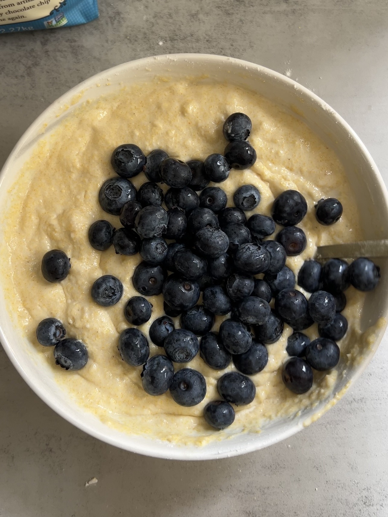 folding the blueberries into the cornbread batter