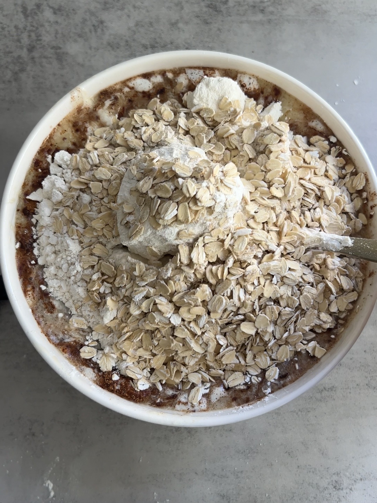 adding the remaining cinnamon roll banana bread ingredients