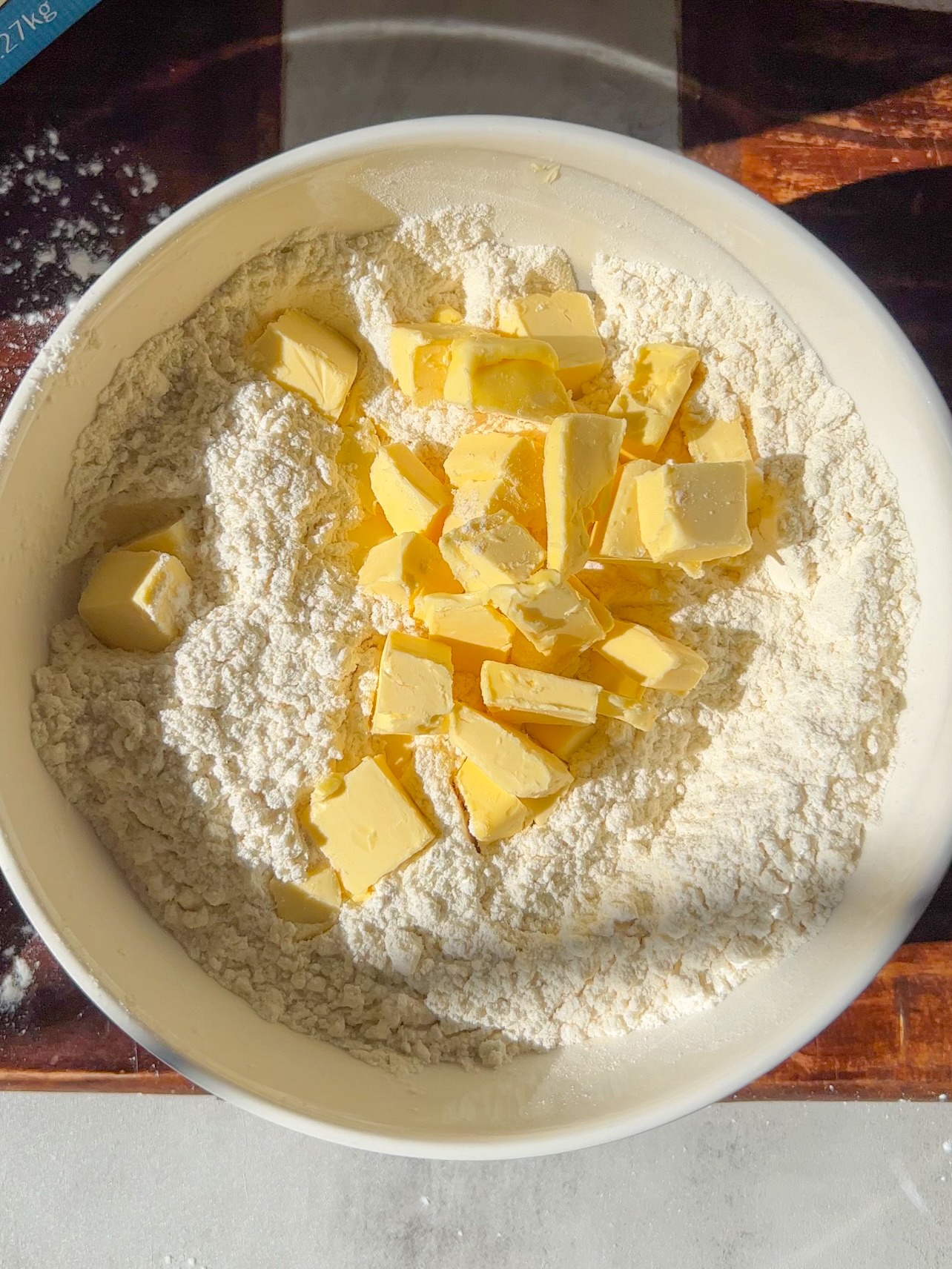 adding the sliced butter to the flour