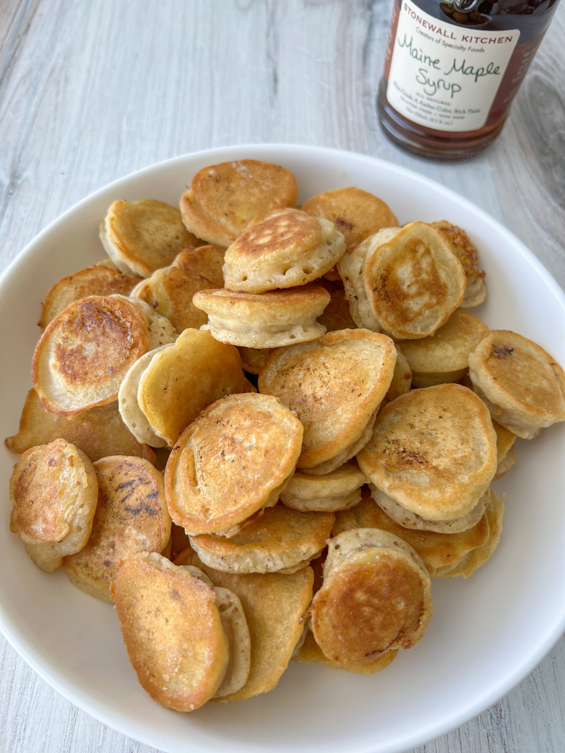 Banana pancake bites on a plate after being cooked. 