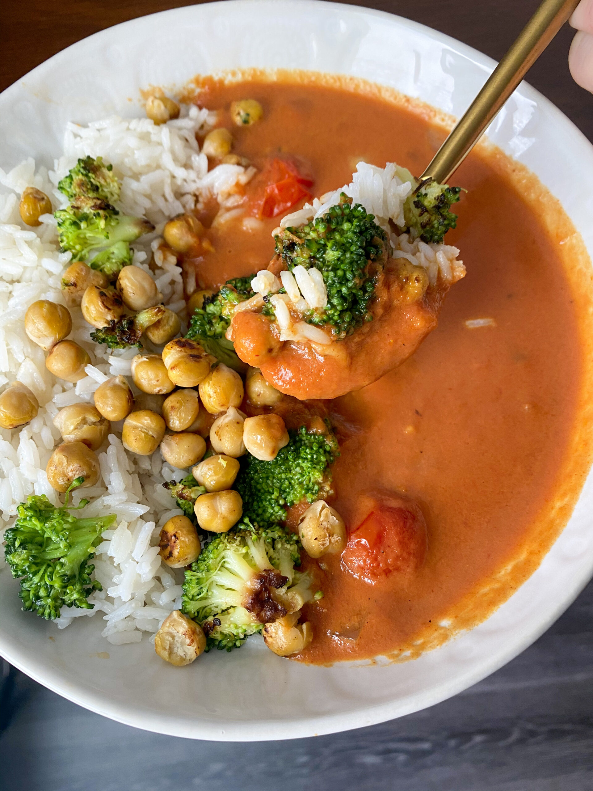 Vegan curry served with broccoli, rice and chickpeas.