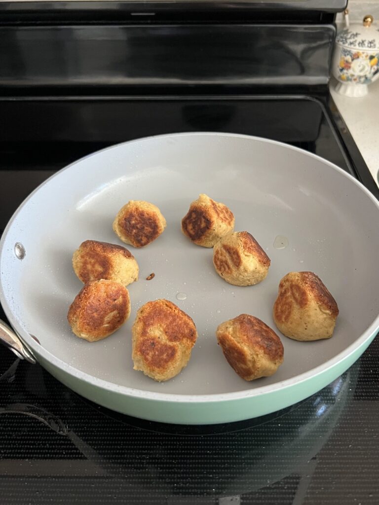 Chickpea meatballs after being fried in a pan. 