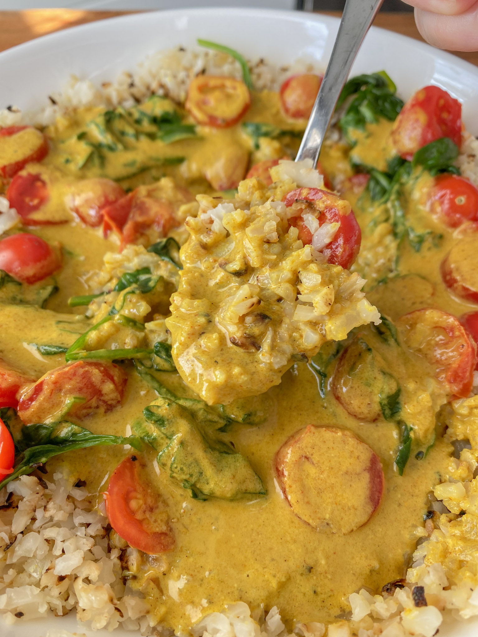 Vegan Coconut Curry with a spoon scooping up a bite. 