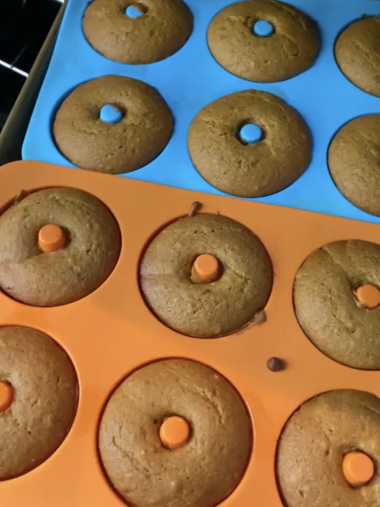 Pumpkin donuts after being baked in the donut pans. 