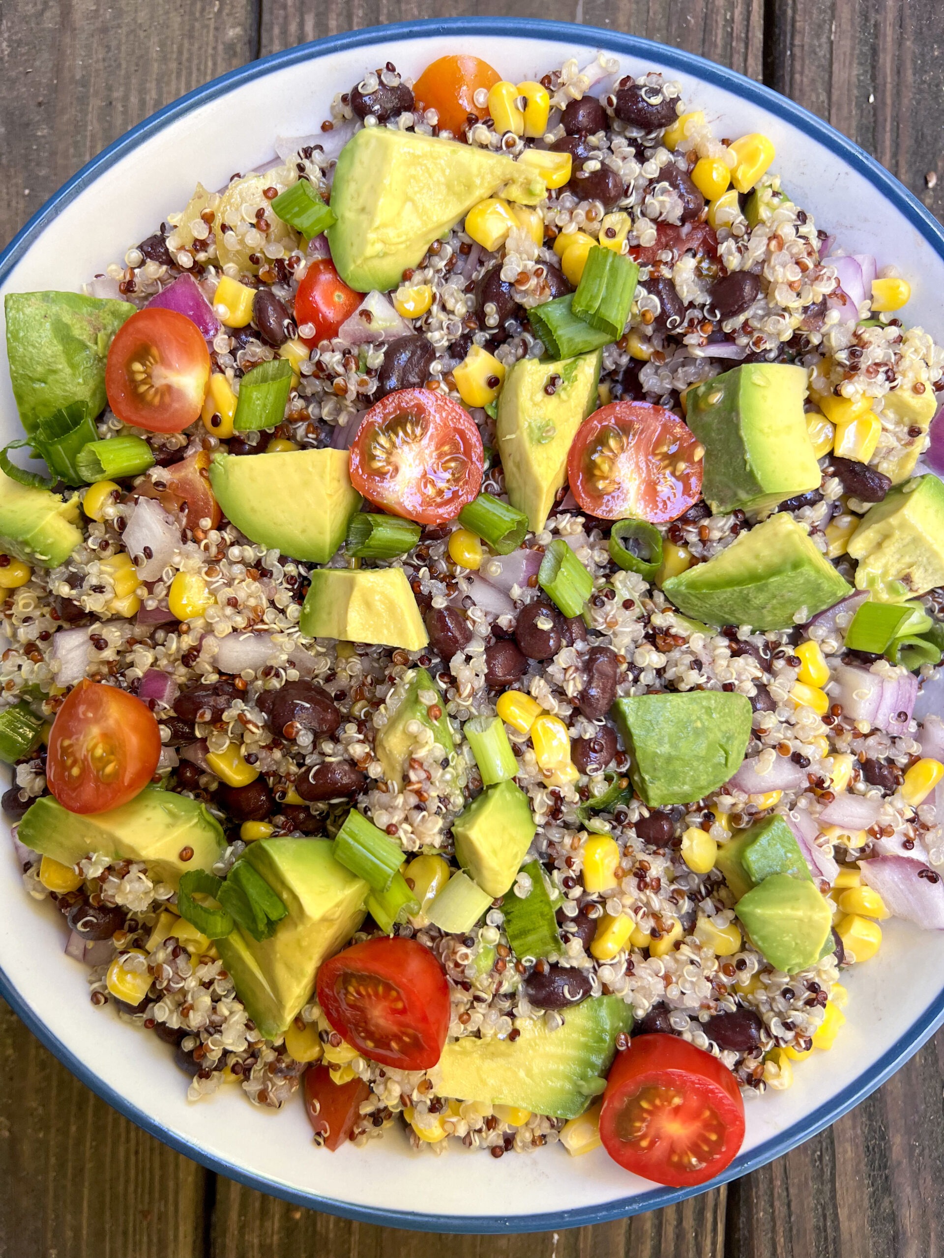 Southwestern quinoa and black bean salad mixed together in a white bowl. 