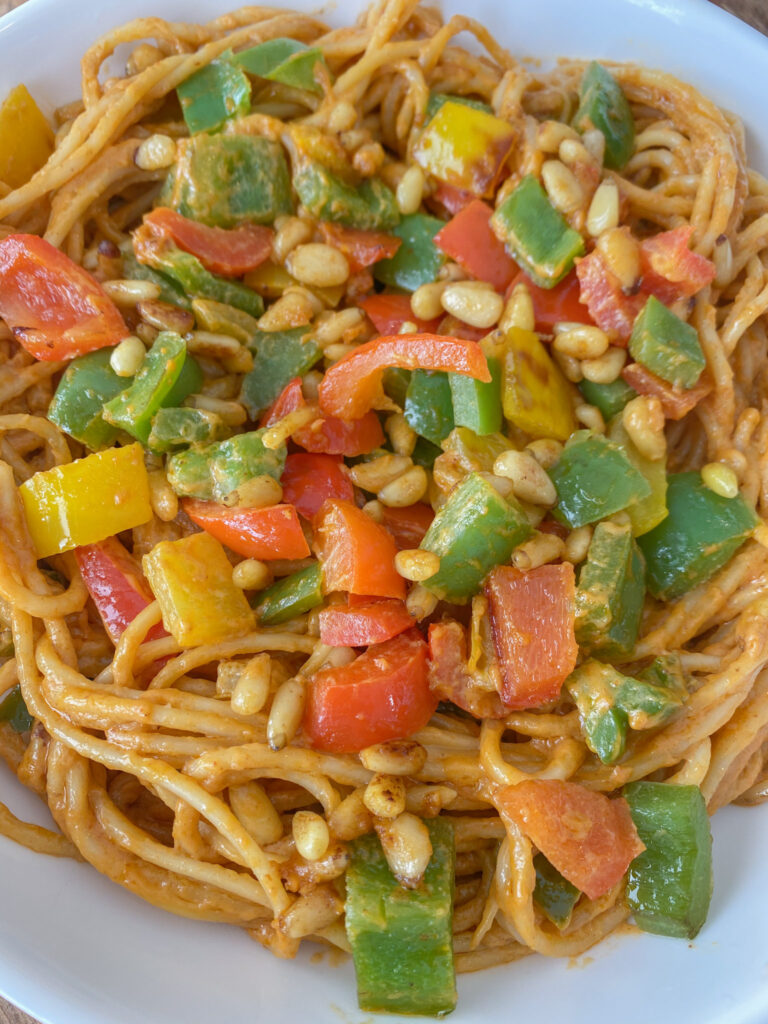 Final vegan peanut noodles in a white bowl. 