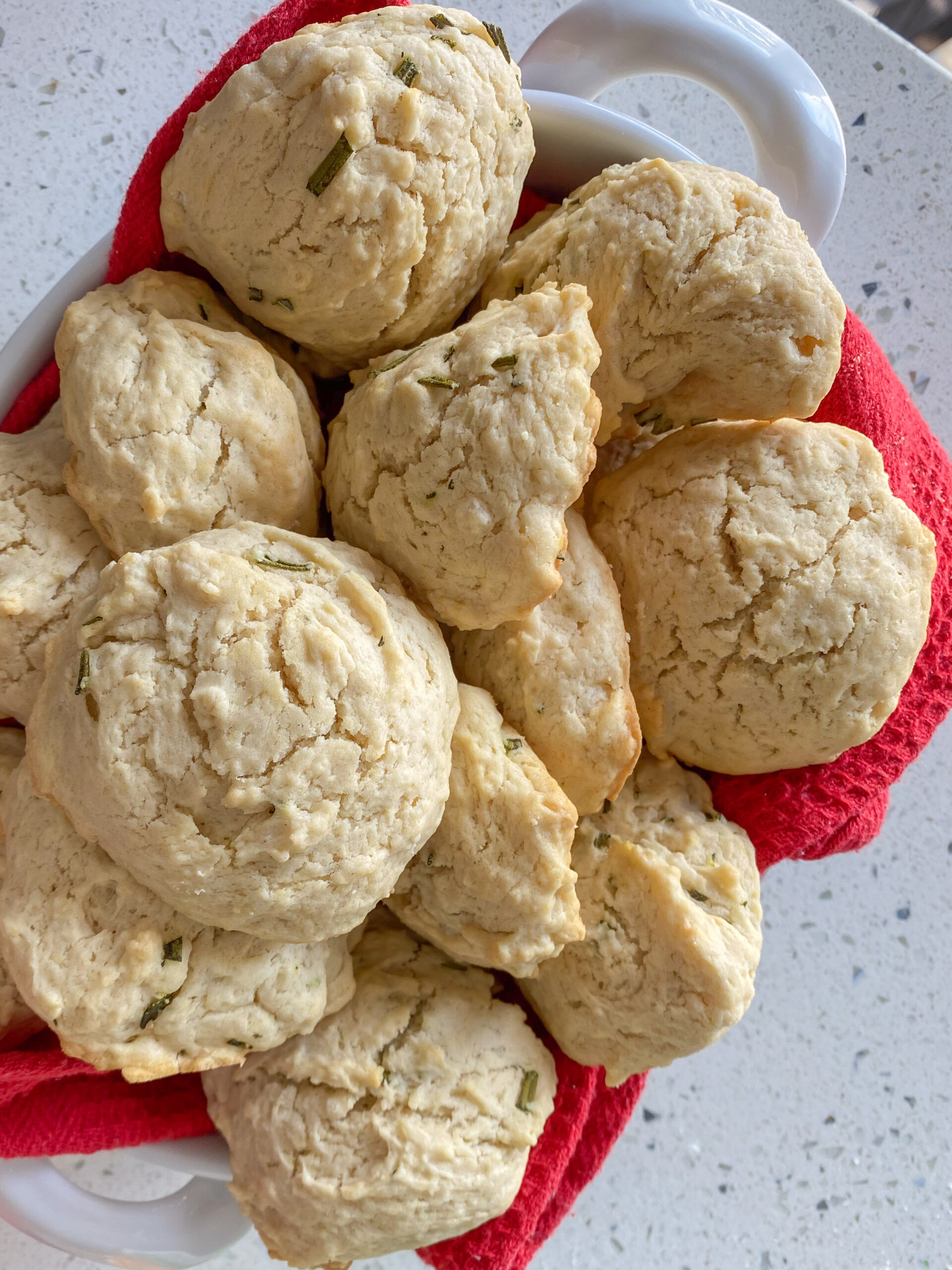 a basket of rosemary maple biscuits