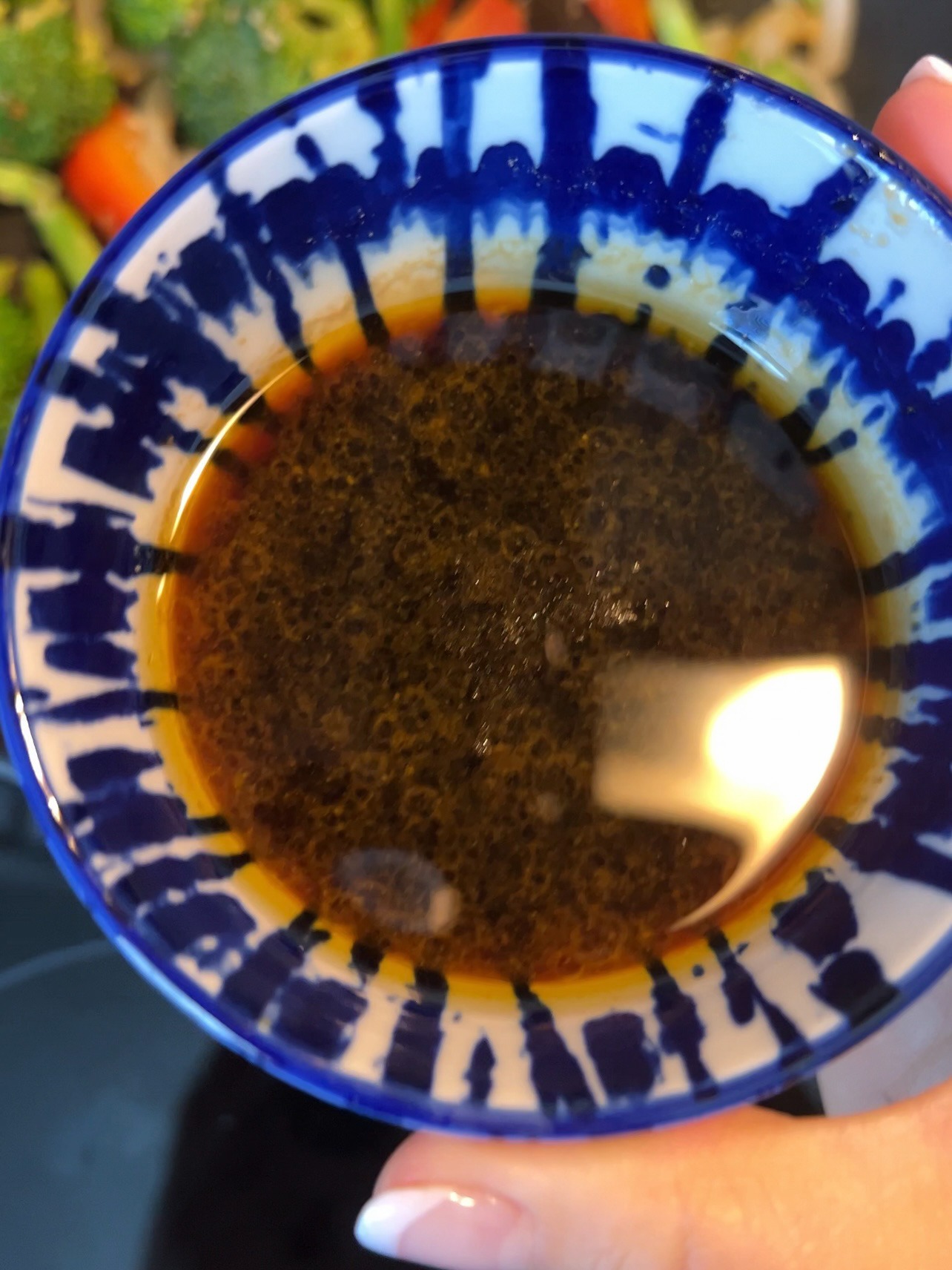 Mixing together ingredients for Mongolian sauce in a small bowl.