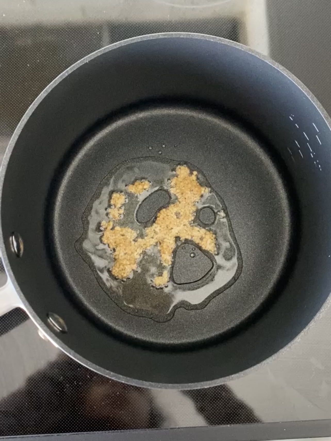 Sautéing garlic in a pot.