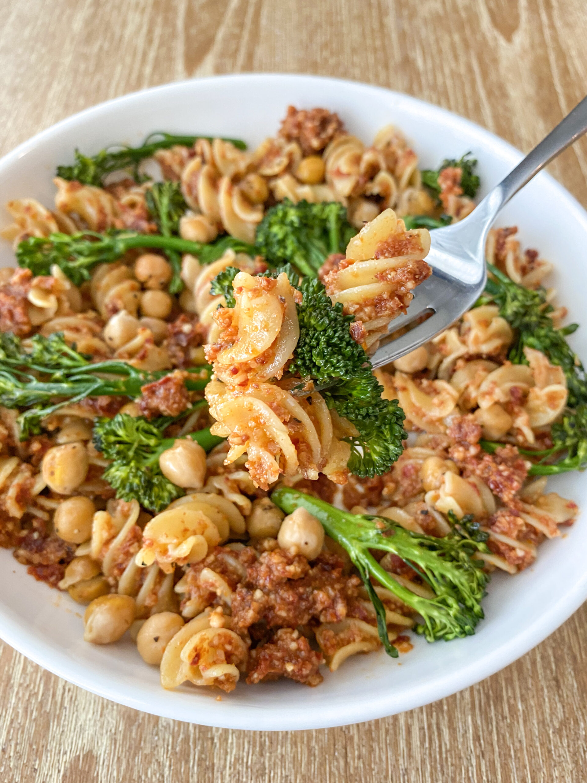 Pasta on a fork with broccoli.