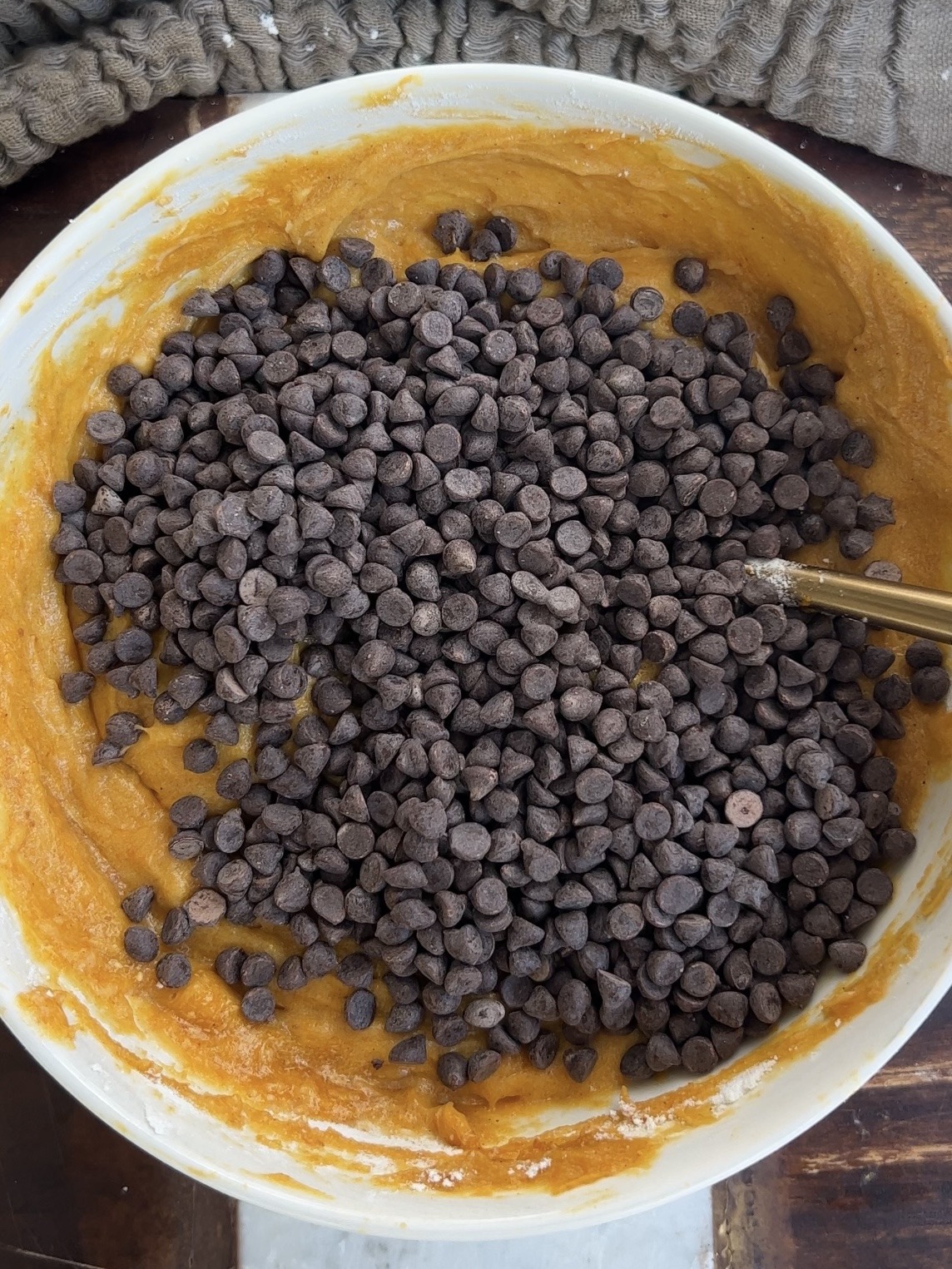 folding the chocolate chips into the pumpkin bar batter
