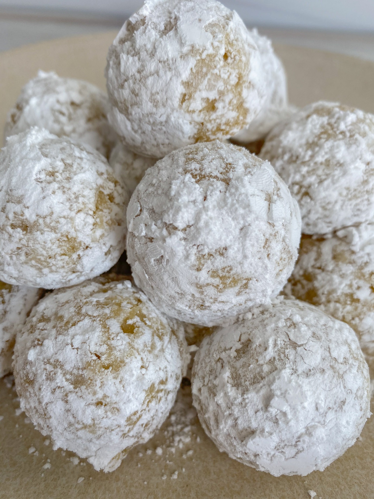 A batch of powdered sugar donuts.