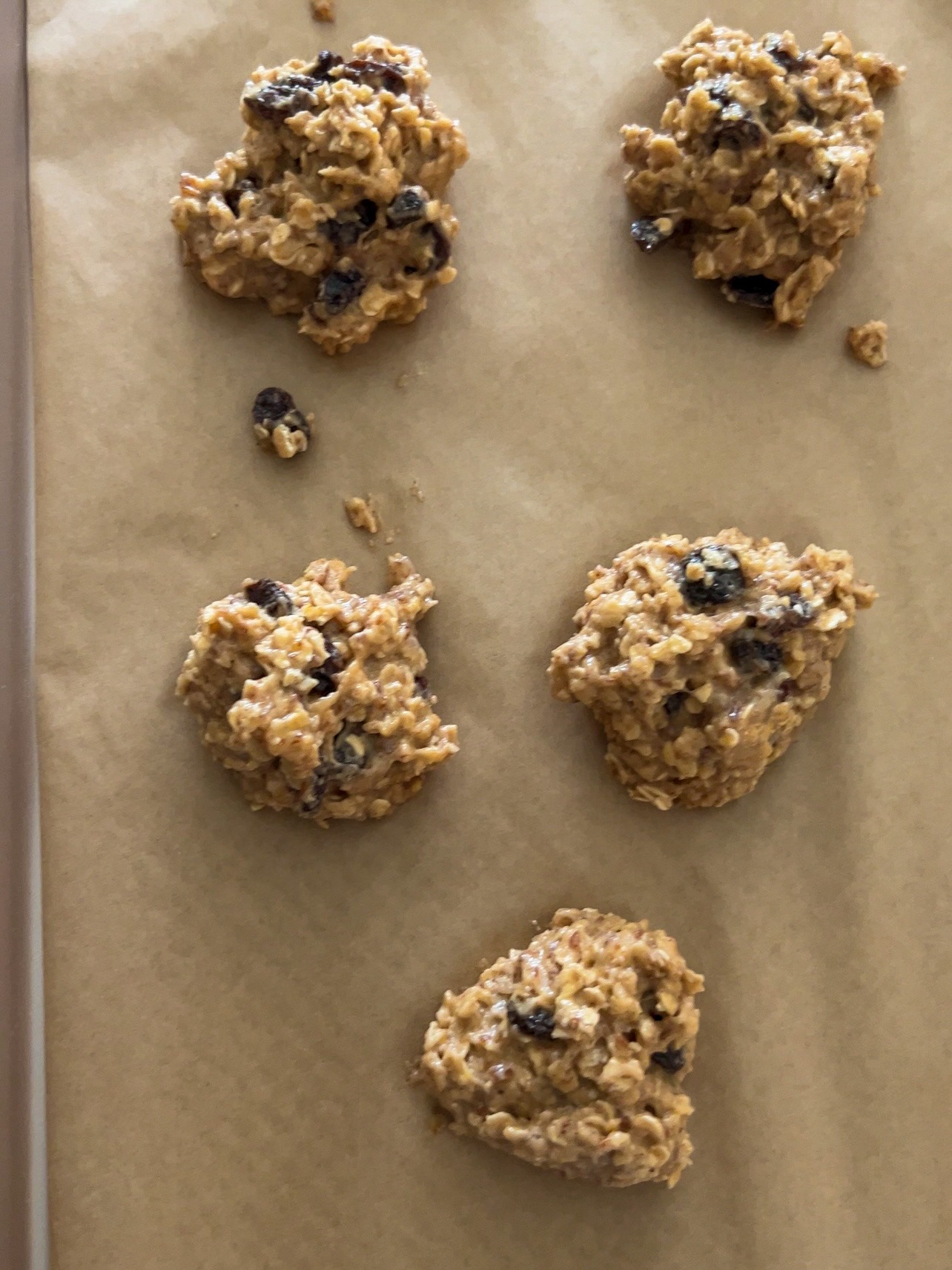 placing the alyssas cookie batter onto the baking sheet lined with parchment paper