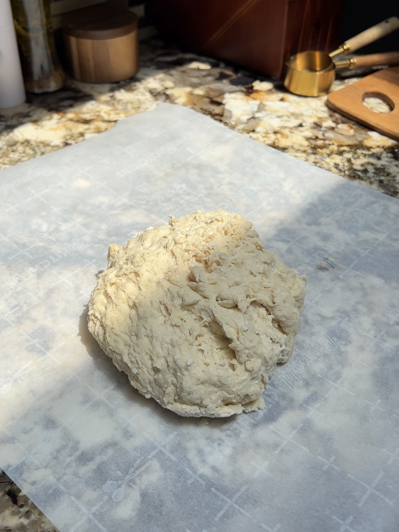 dough for the crust of the pecan pie sitting on a piece of parchment paper 