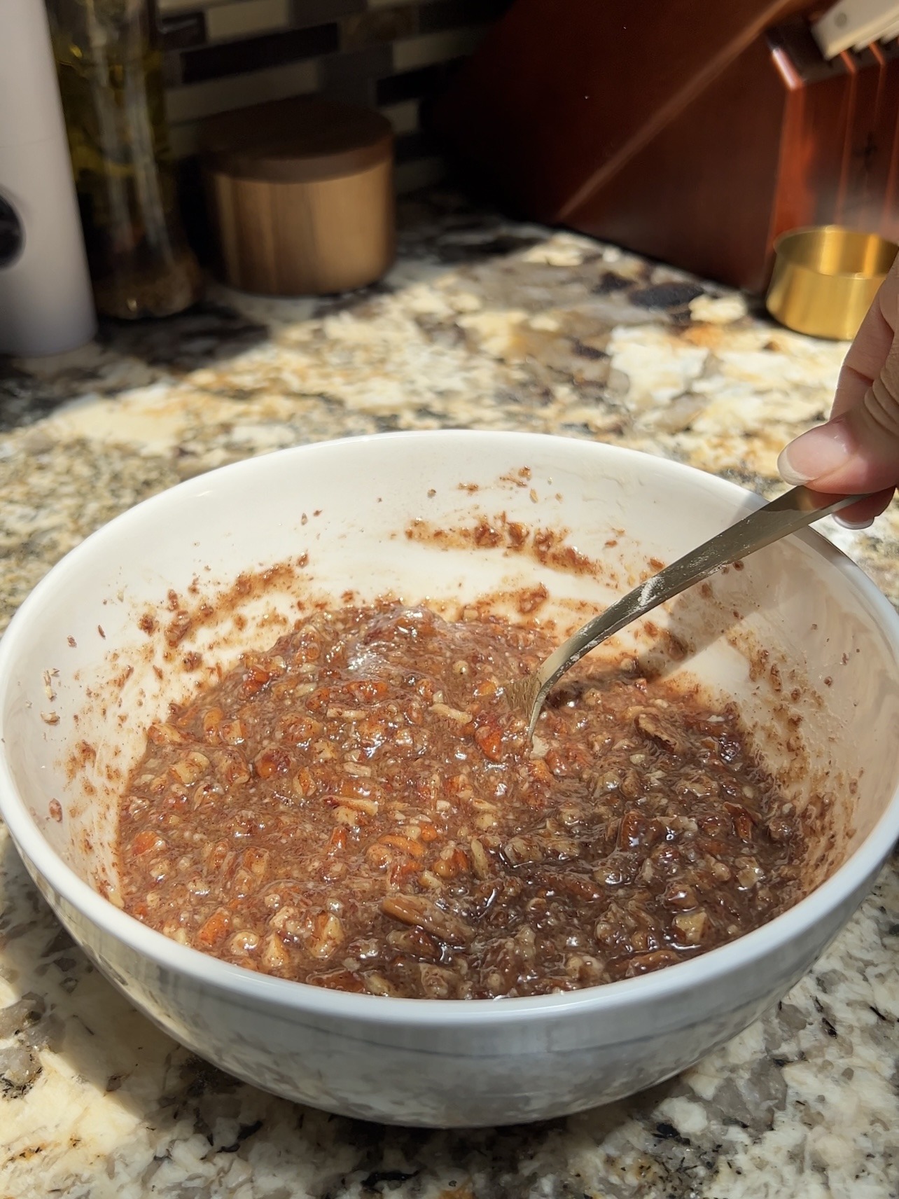 Mixing the vegan pecan pie filling in a bowl