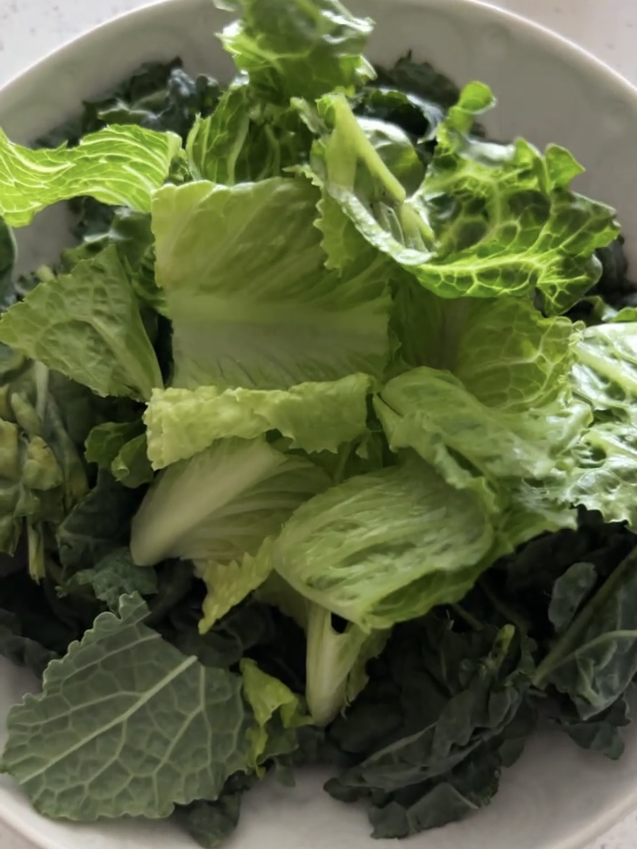 Greens in a white bowl. 