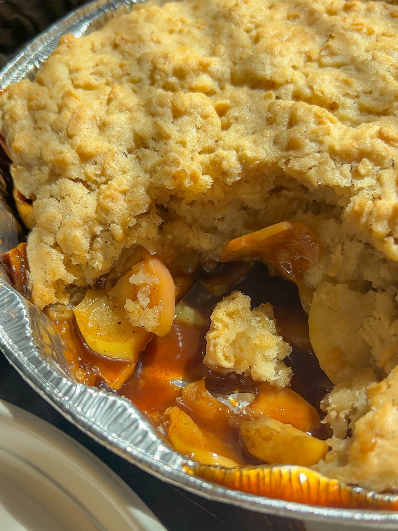 close up of the freshly scooped apple cobbler