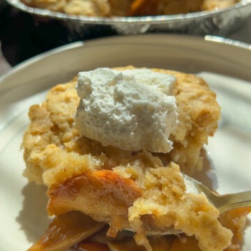 easy apple cobbler with whipped cream on top