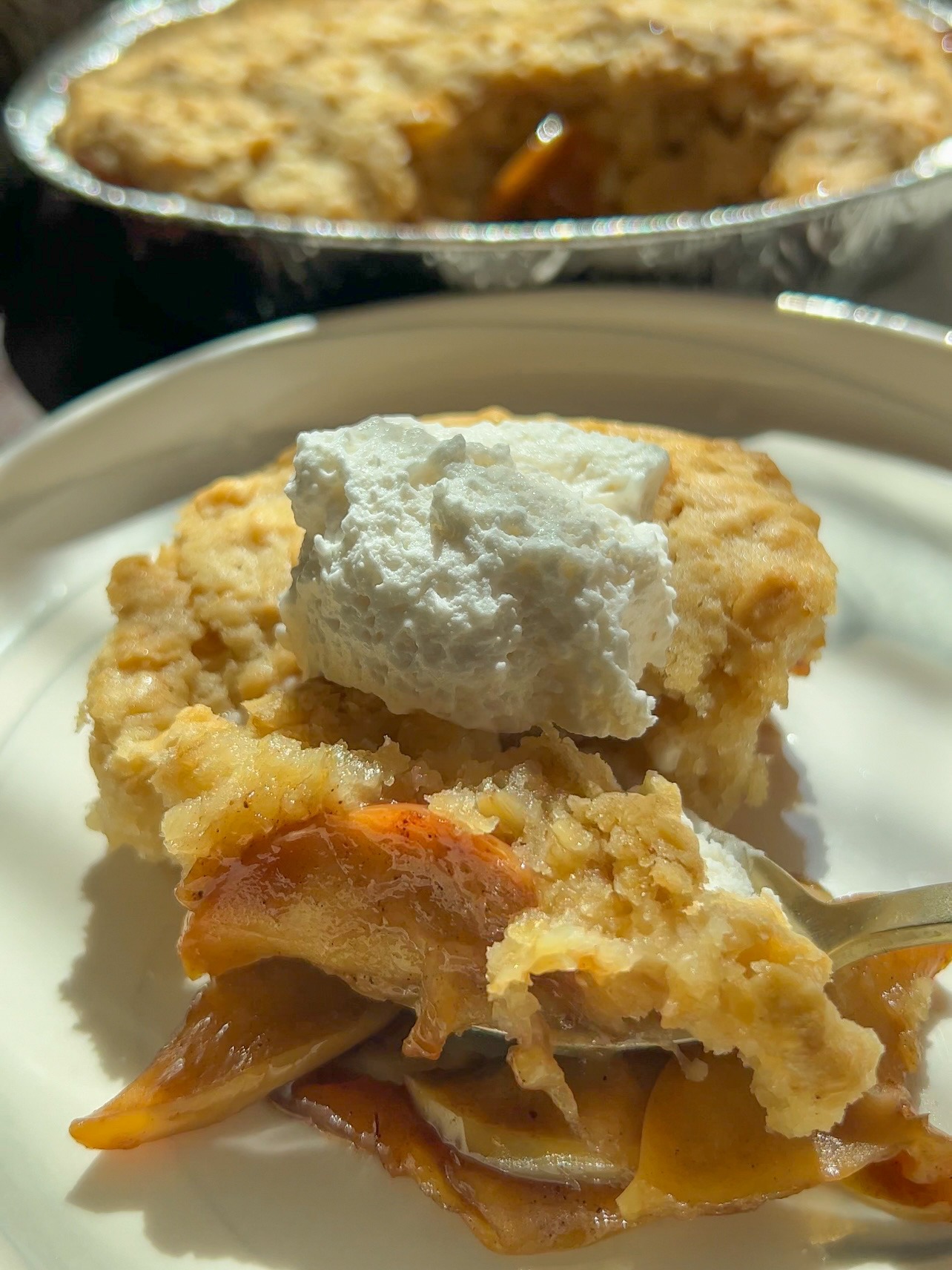 easy apple cobbler with whipped cream on top