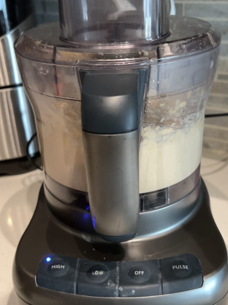 Blending hummus in a food processor.