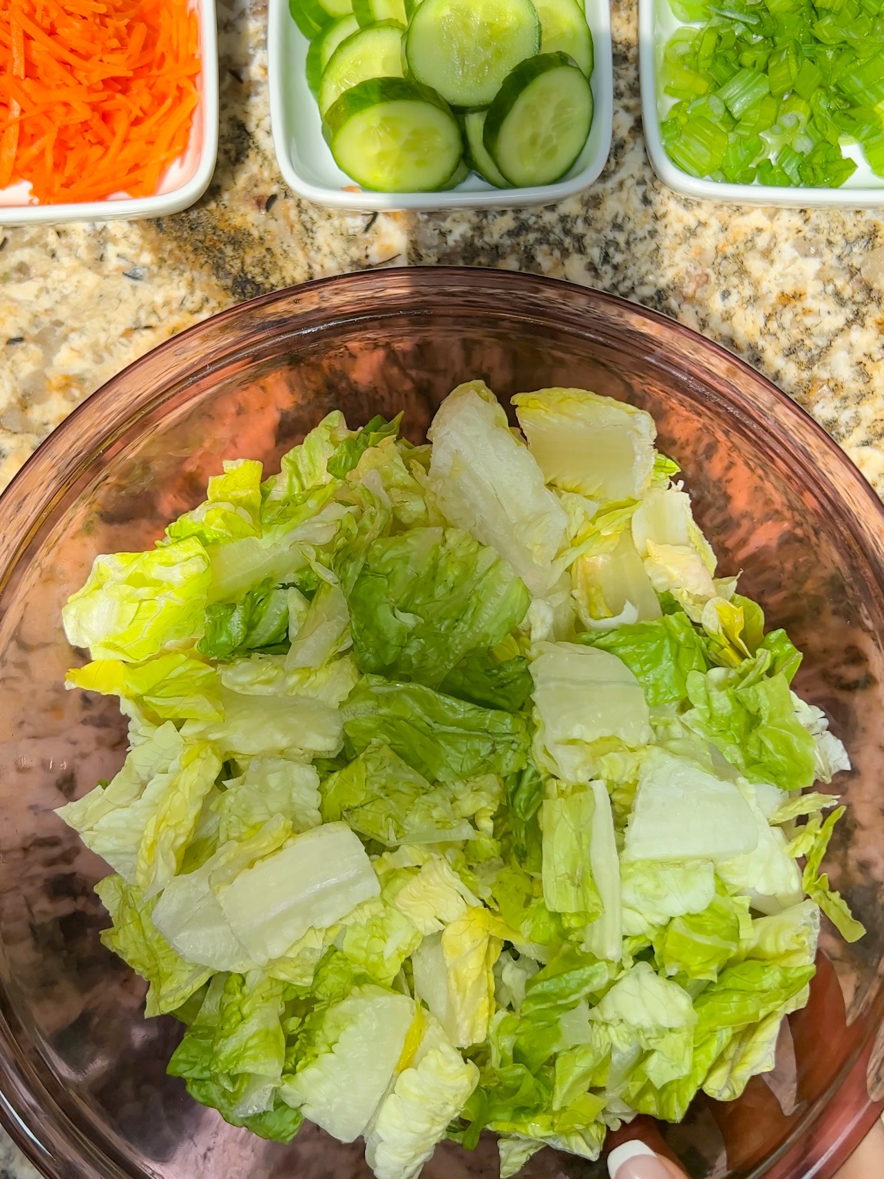 adding ingredients to cashew crunch salad