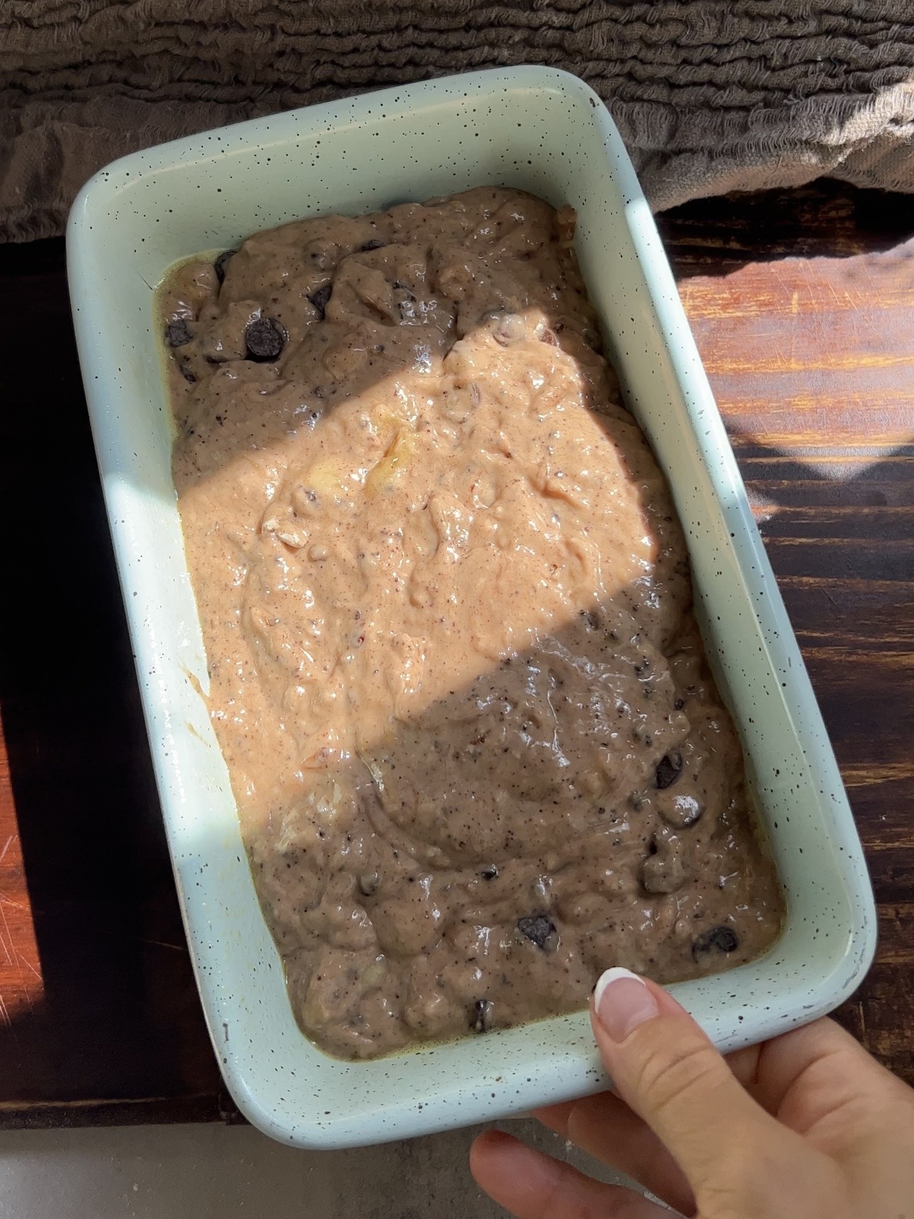 pouring the batter into the greased loaf pan