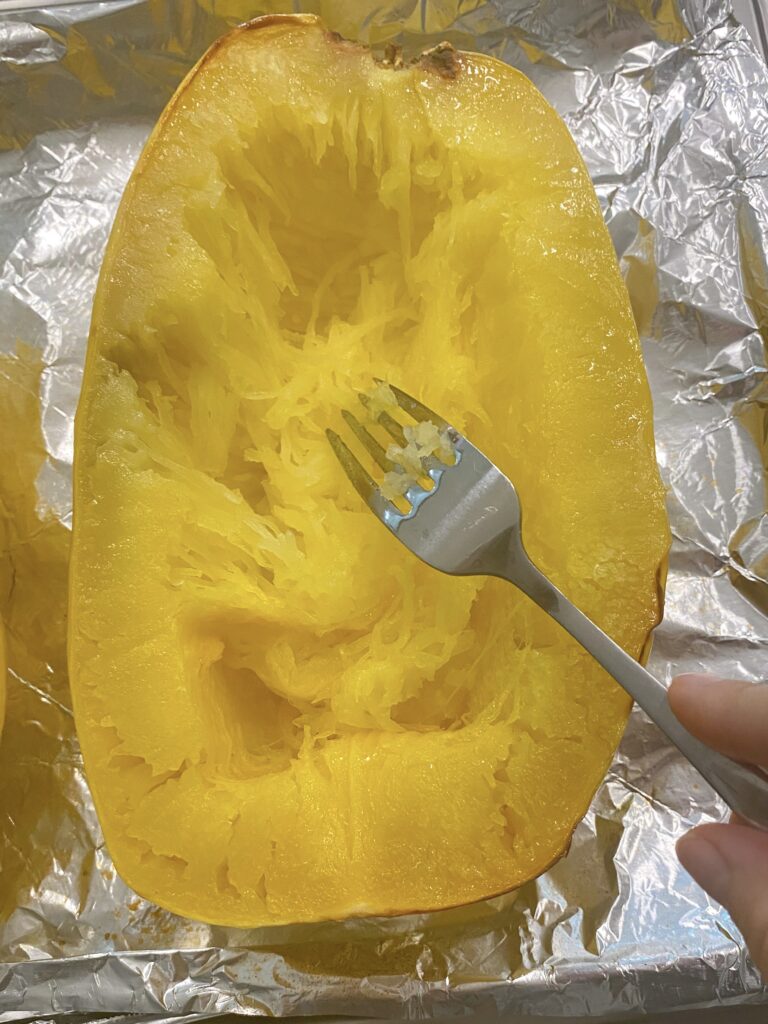 Using a fork to pull out the squash noodles.