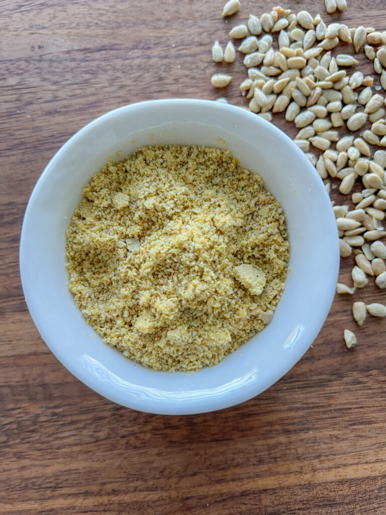 vegan parmesan cheese in a white bowl. 