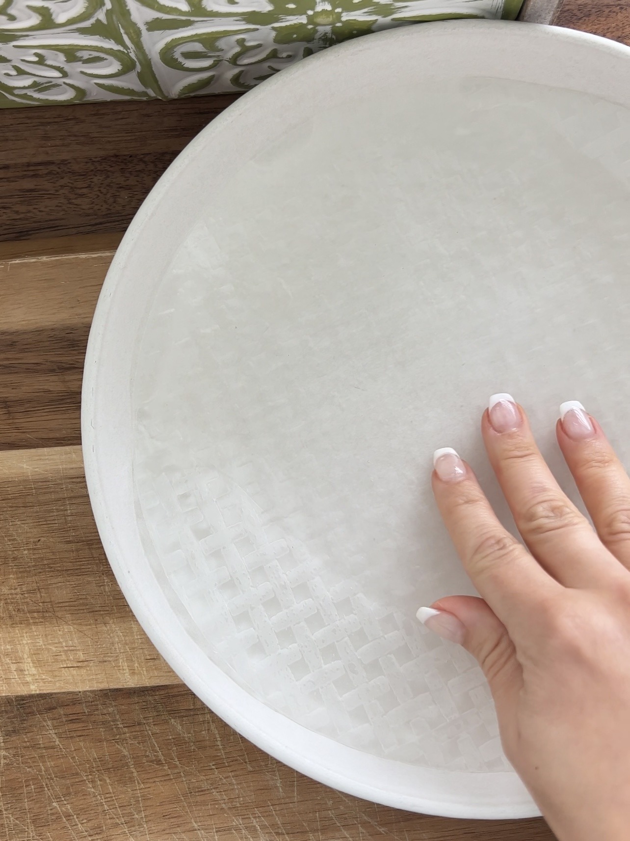 dipping the rice paper into warm water to make the vegan spring rolls