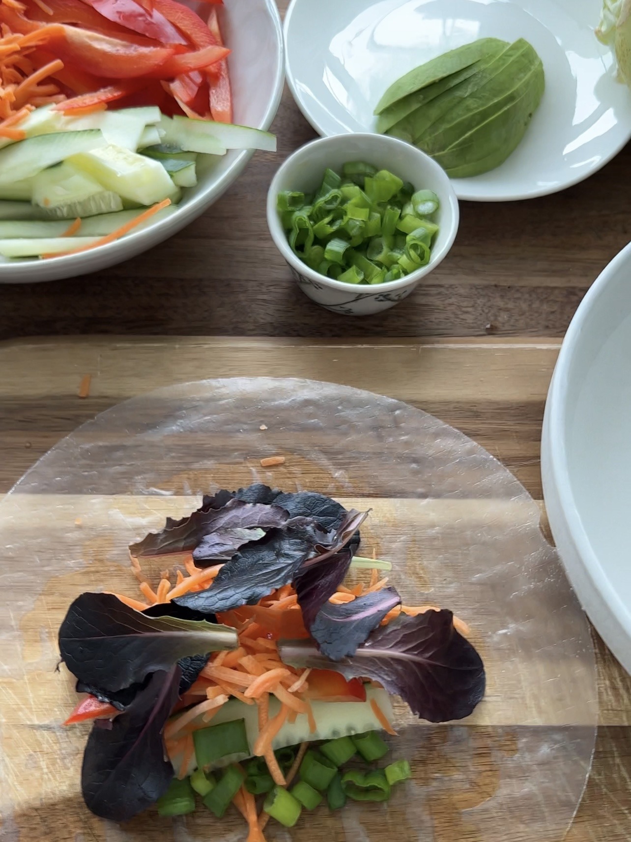 filling the vegan spring rolls with fresh veggies