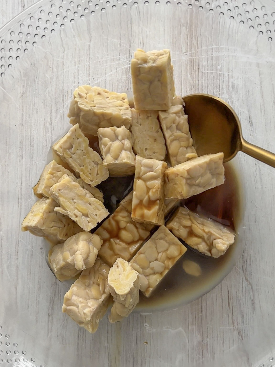 marinated tempeh in mixing bowl