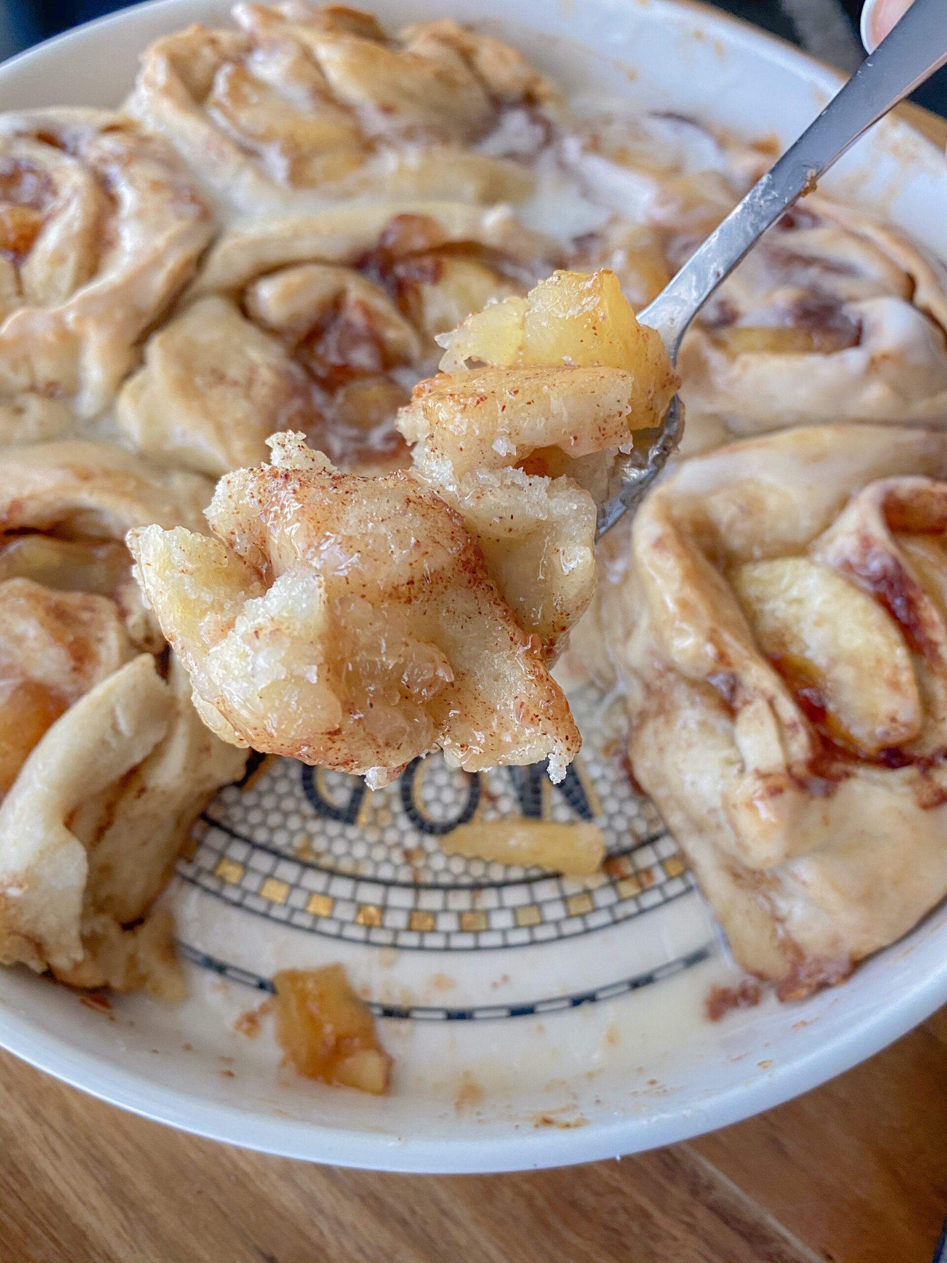 close up of taking a bite of apple cinnamon rolls